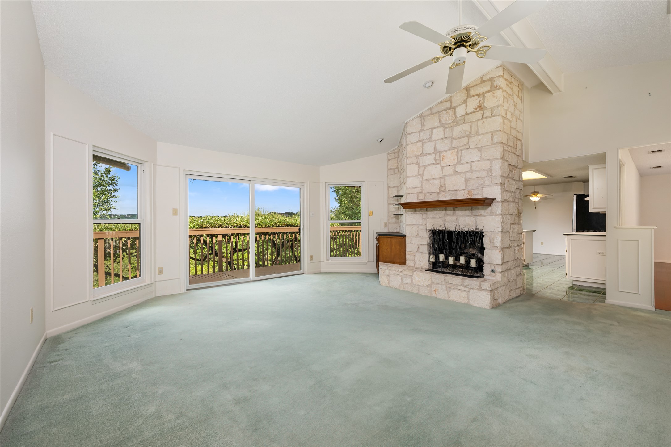 5319 Musket Ridge Austin, TX 78759 - Photo 9 of 39 A spacious living area with a grand stone fireplace and immediate access to a private balcony.