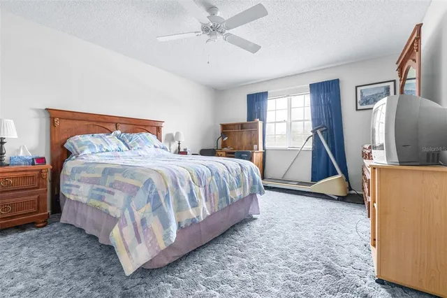 a bedroom with a bed and table