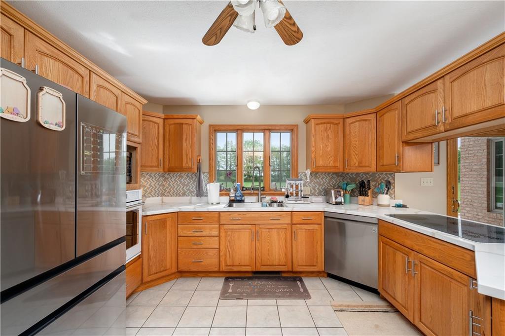 258 Smith Road Renfrew, PA 16053 - Photo 26 of 50 a kitchen with a sink window and cabinets