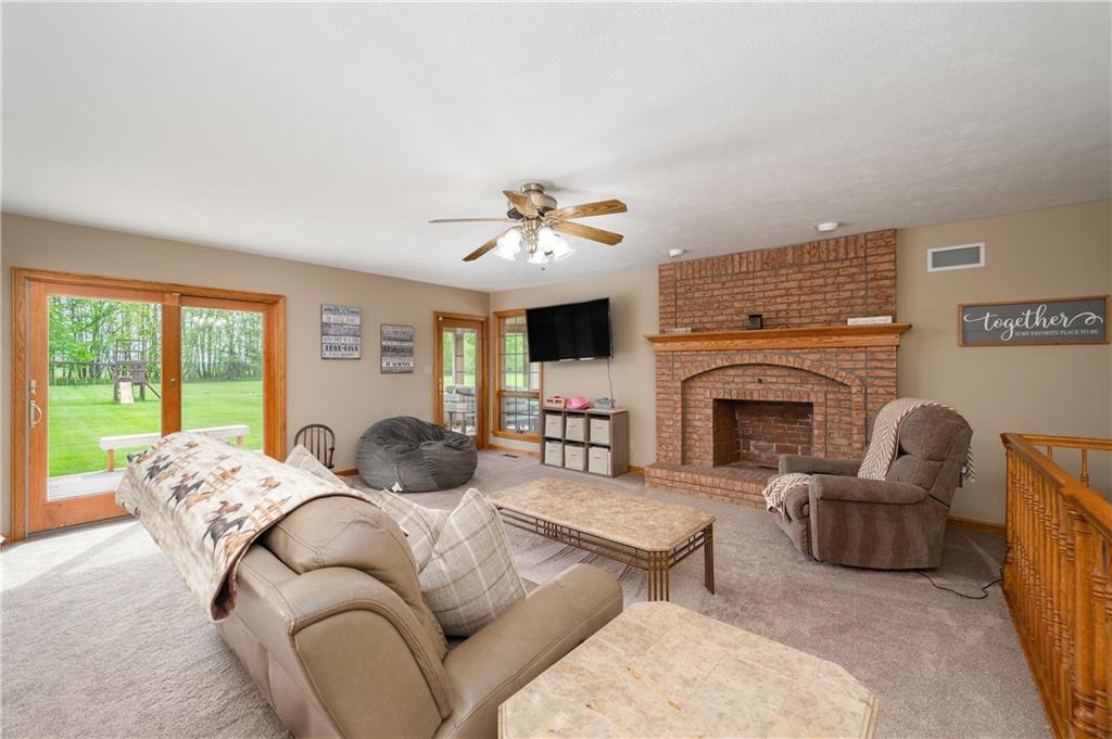 258 Smith Road Renfrew, PA 16053 - Photo 31 of 50 a living room with furniture fireplace and a large window
