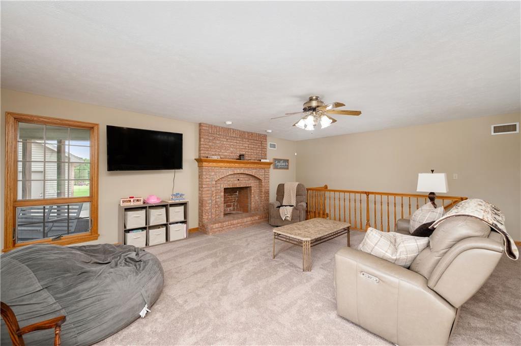 258 Smith Road Renfrew, PA 16053 - Photo 33 of 50 a living room with furniture fireplace and flat screen tv