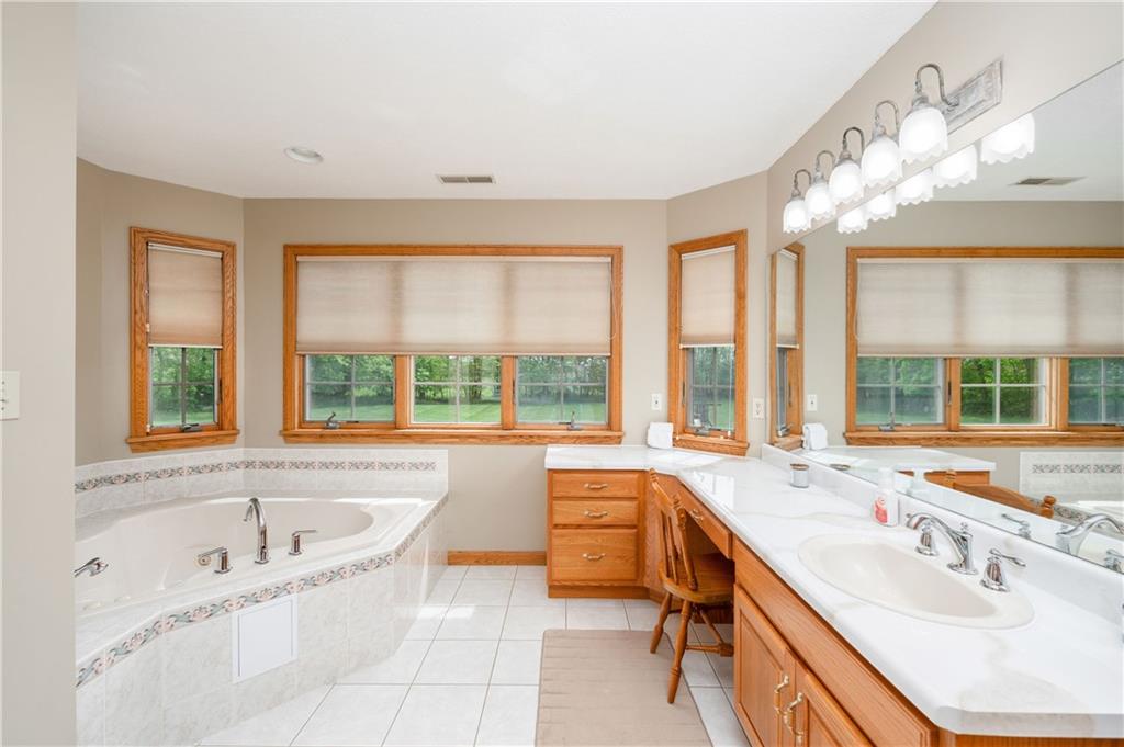 258 Smith Road Renfrew, PA 16053 - Photo 39 of 50 a spacious bathroom with a tub sink and large windows