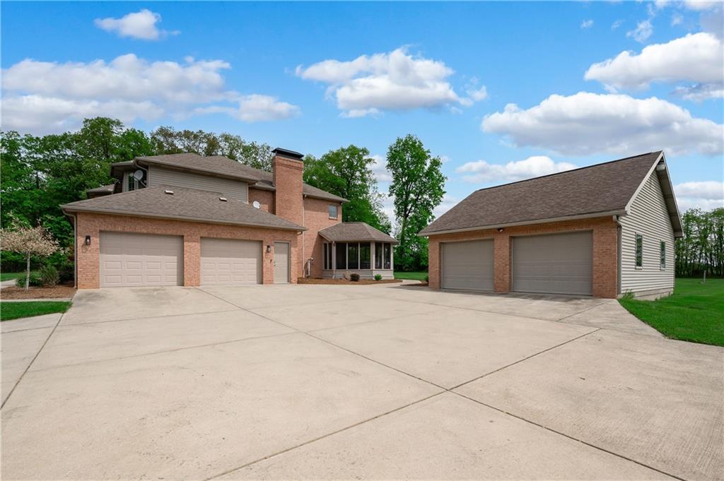 258 Smith Road Renfrew, PA 16053 - Photo 6 of 50 a front view of a house with a yard and garage