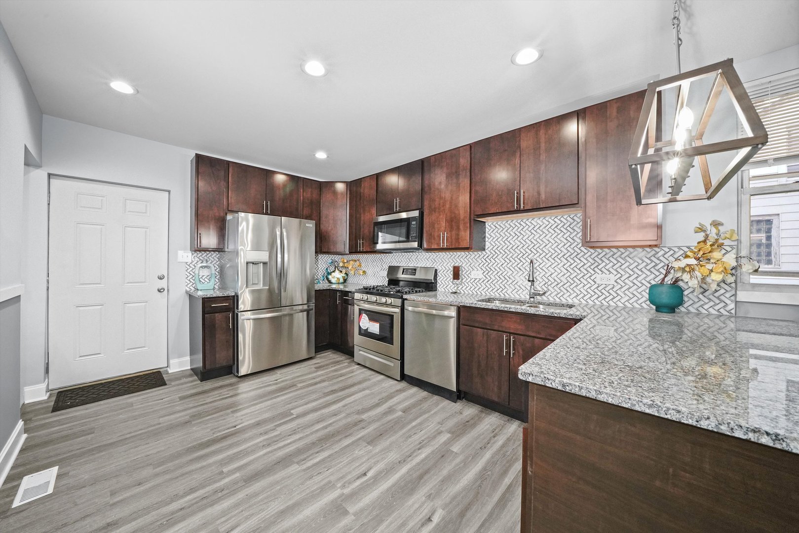 60 East 103rd Place Chicago, IL 60628 - Photo 12 of 20 a kitchen with stainless steel appliances granite countertop a refrigerator sink and cabinets