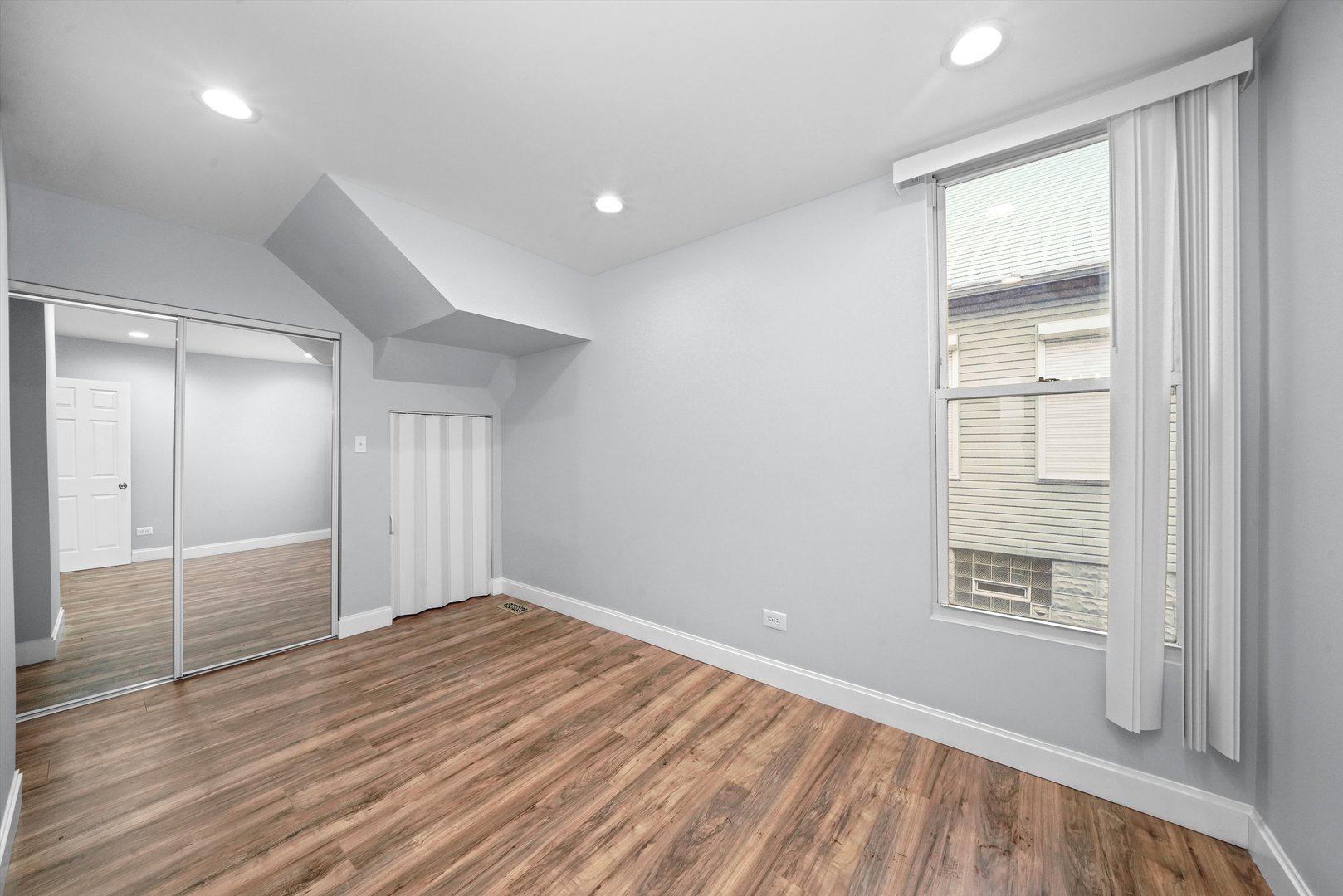 60 East 103rd Place Chicago, IL 60628 - Photo 15 of 20 wooden floor in an empty room with a window