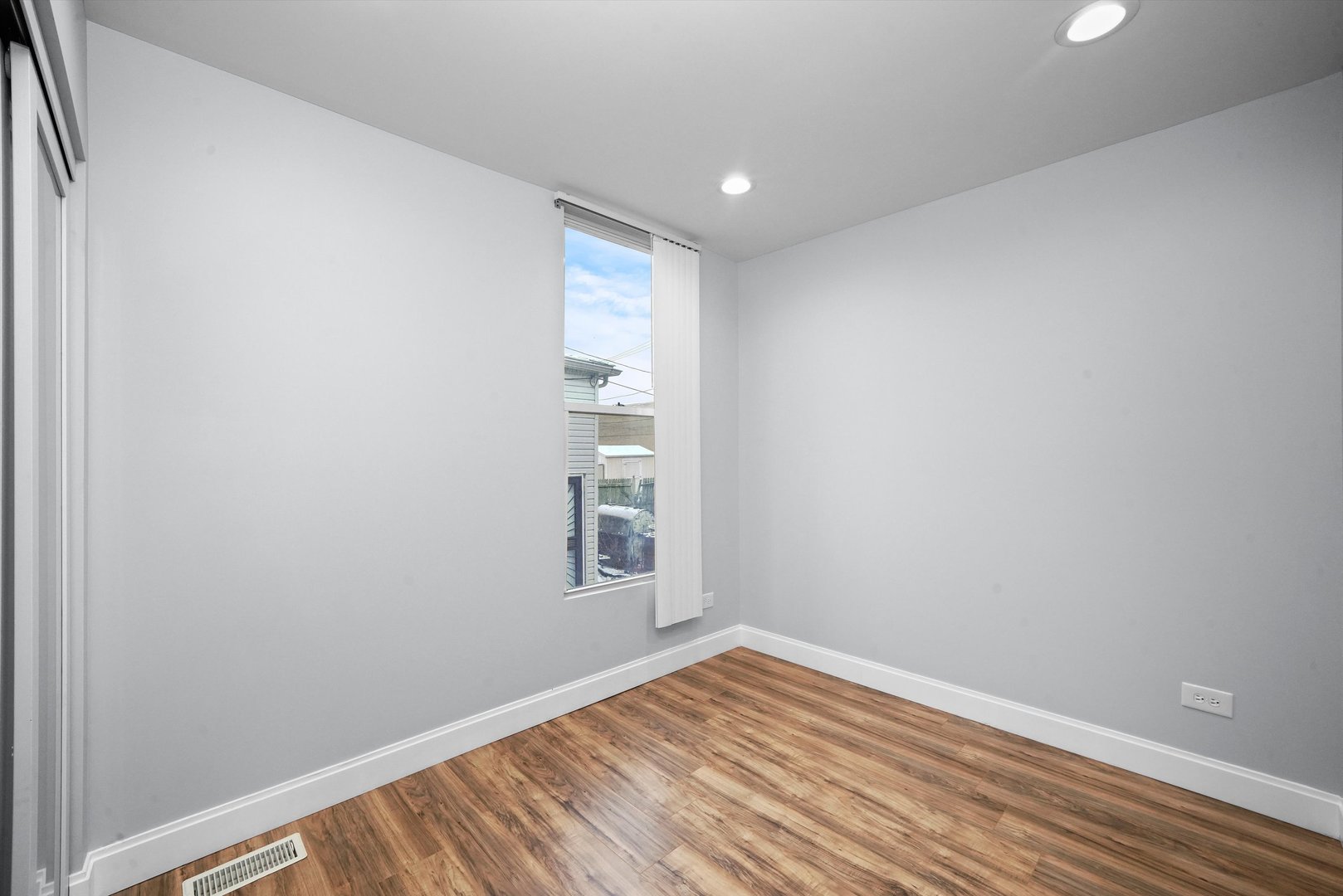 60 East 103rd Place Chicago, IL 60628 - Photo 16 of 20 a view of empty room with wooden floor and fan