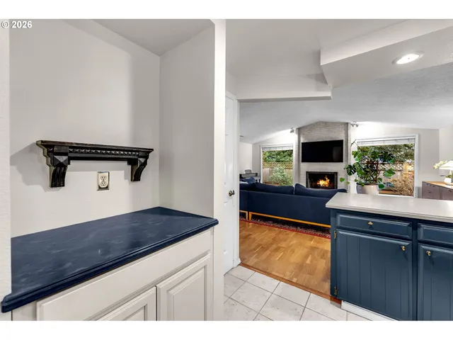 a kitchen with granite countertop a sink stove and cabinets