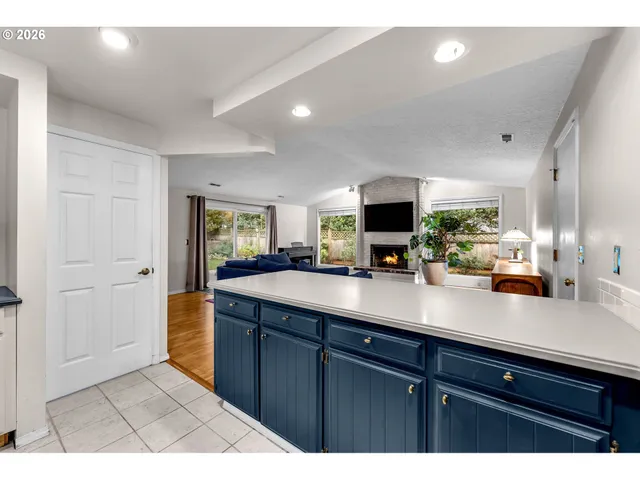 a view of kitchen with sink and mirror