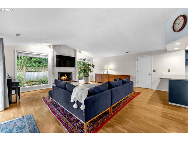 a living room with furniture fireplace and a flat screen tv