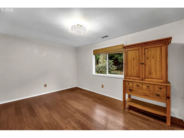 a view of a room with wooden floor and window