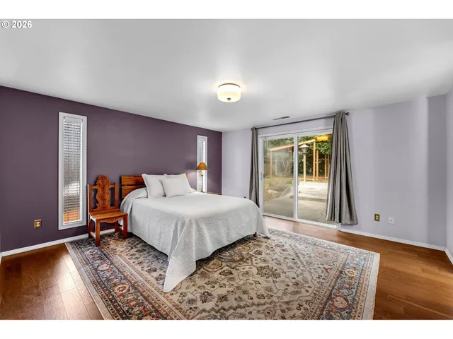 a bedroom with a large bed and a window