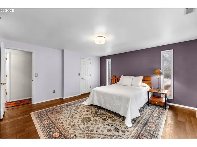 a bedroom with a bed and a night stand