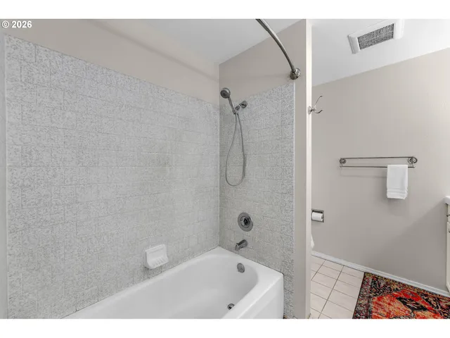 a bathroom with a bath tub and shower