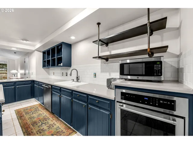 a kitchen with stainless steel appliances kitchen island a sink and cabinets