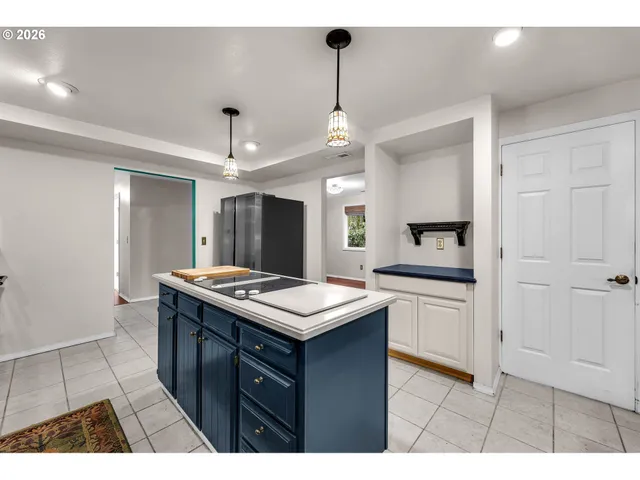 a kitchen with a stove a sink a refrigerator and a window