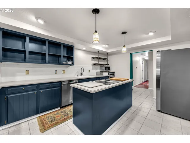 a kitchen with a stove a refrigerator and a sink