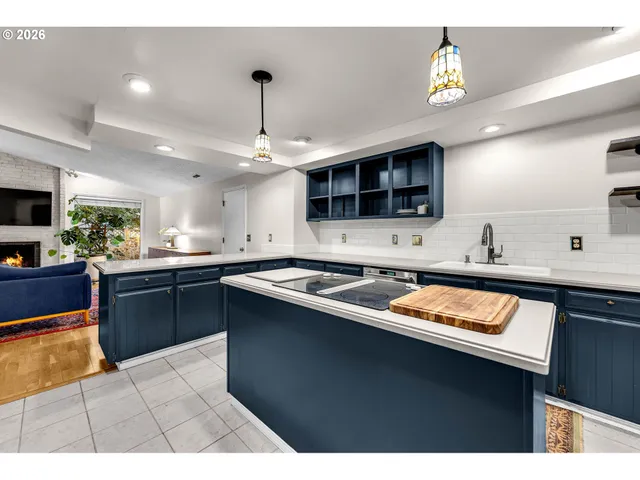 a kitchen with stainless steel appliances kitchen island granite countertop a sink dishwasher stove and oven with cabinets