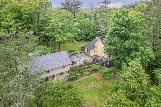 an aerial view of a house with yard and outdoor seating