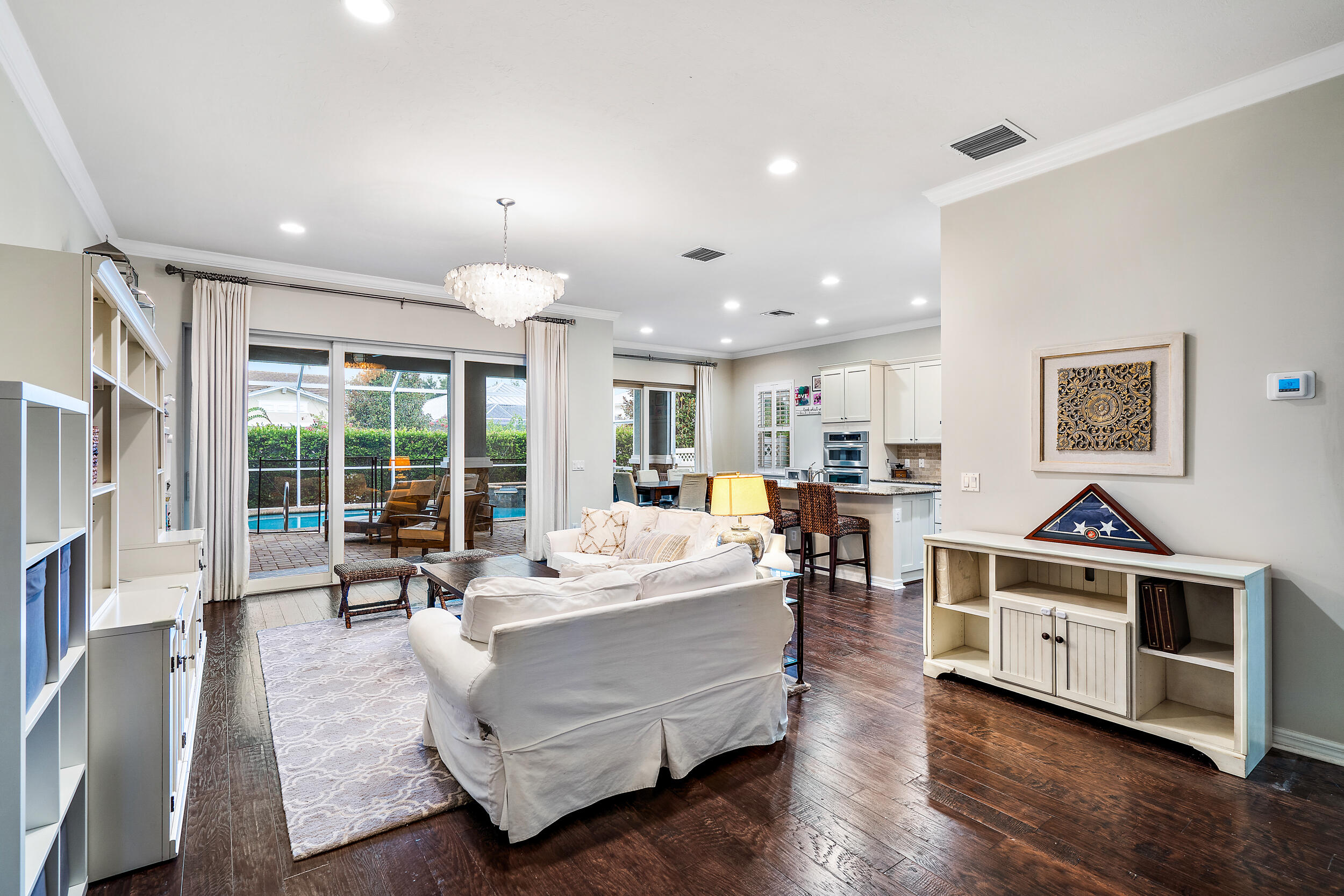 2704 Sunbury Drive Jupiter, FL 33458 - Photo 15 of 50 a living room with furniture a large window and a fireplace
