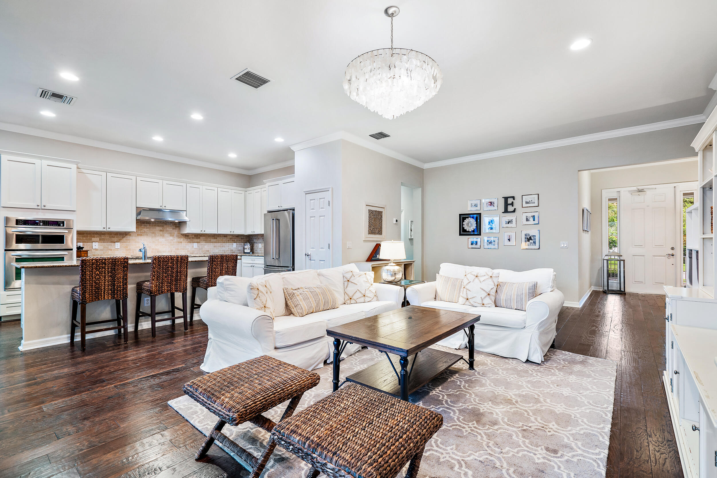 2704 Sunbury Drive Jupiter, FL 33458 - Photo 16 of 50 a living room with lots of furniture and kitchen view