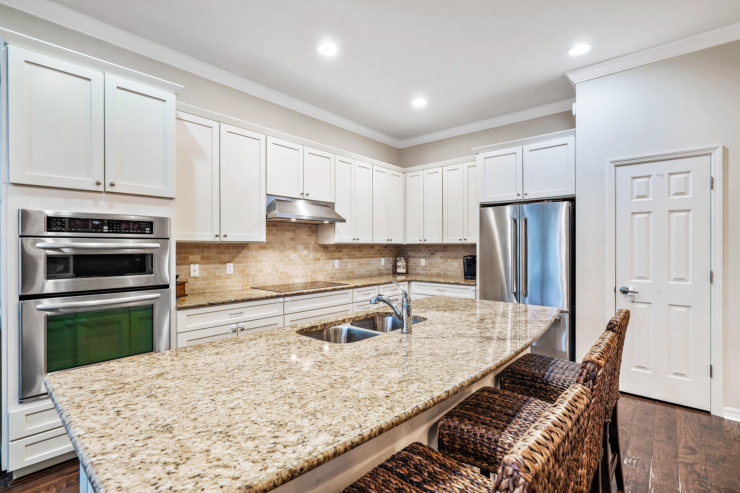 2704 Sunbury Drive Jupiter, FL 33458 - Photo 18 of 50 a kitchen with stainless steel appliances granite countertop a sink stove and refrigerator