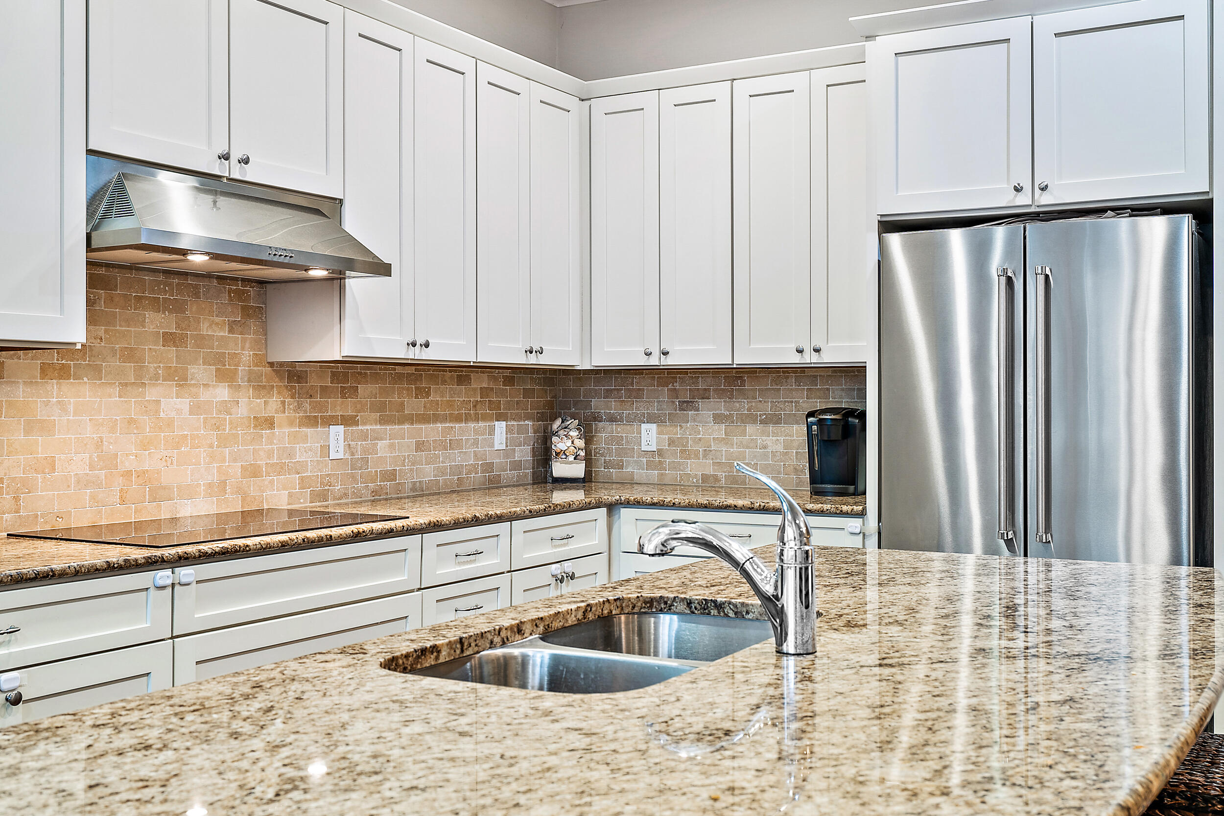2704 Sunbury Drive Jupiter, FL 33458 - Photo 19 of 50 a kitchen with granite countertop a sink a stove and cabinets