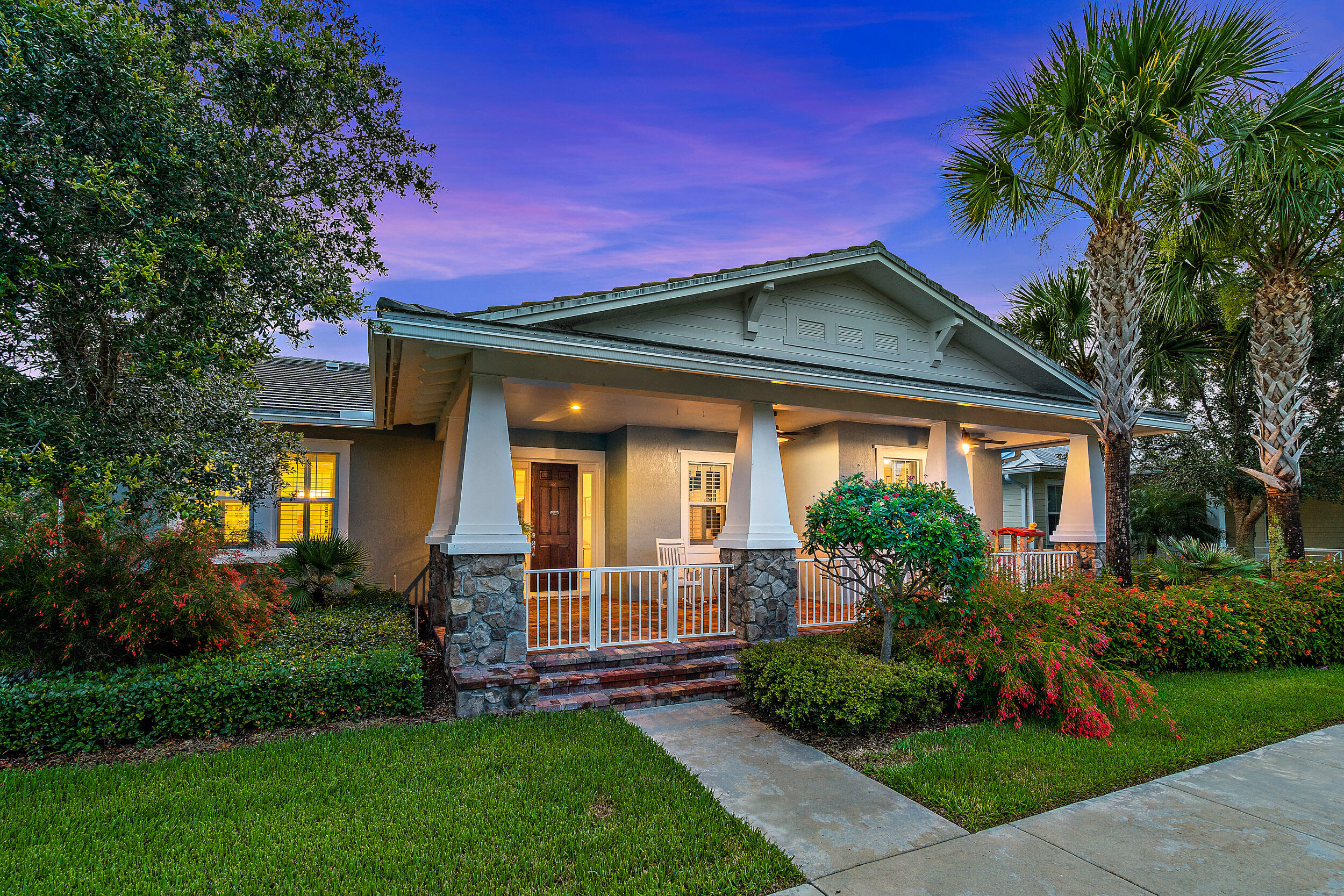 2704 Sunbury Drive Jupiter, FL 33458 - Photo 2 of 50 a front view of a house with a garden