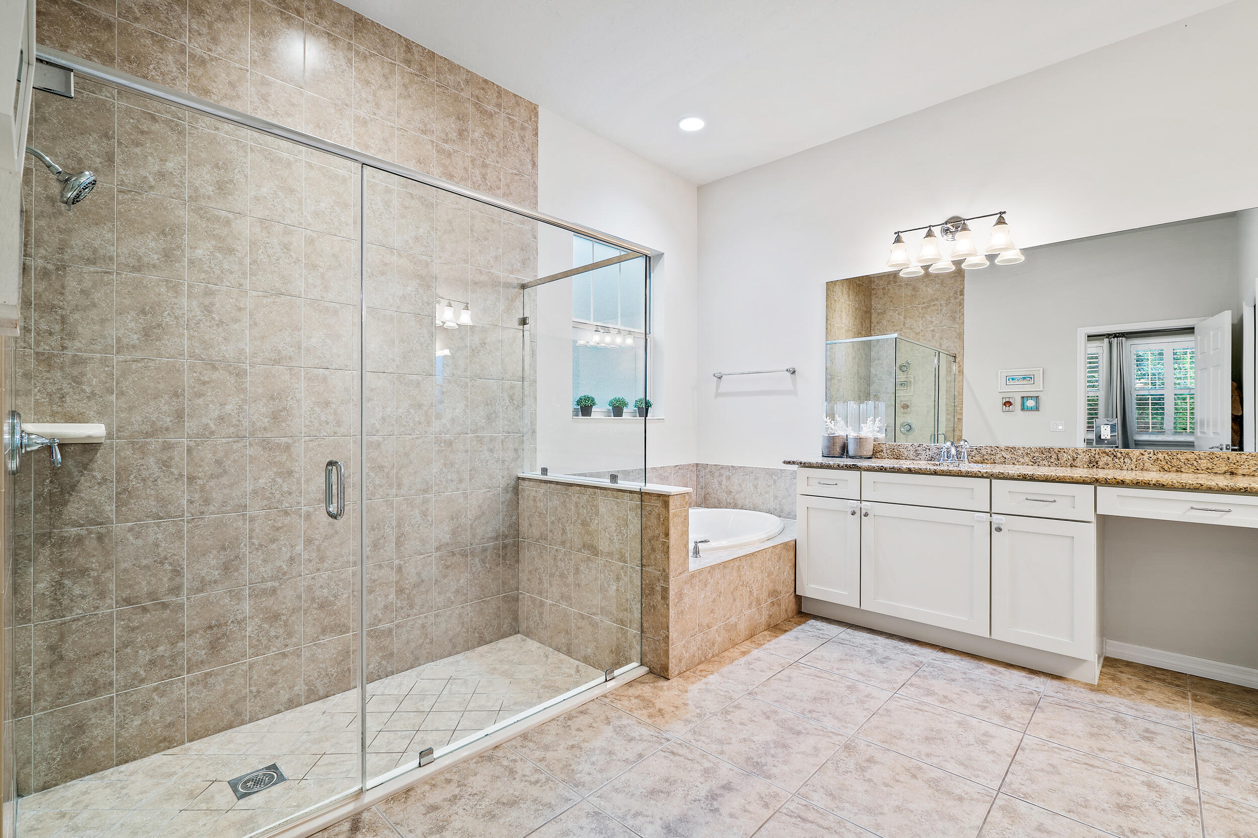 2704 Sunbury Drive Jupiter, FL 33458 - Photo 24 of 50 a bathroom with a tub sink shower and mirror