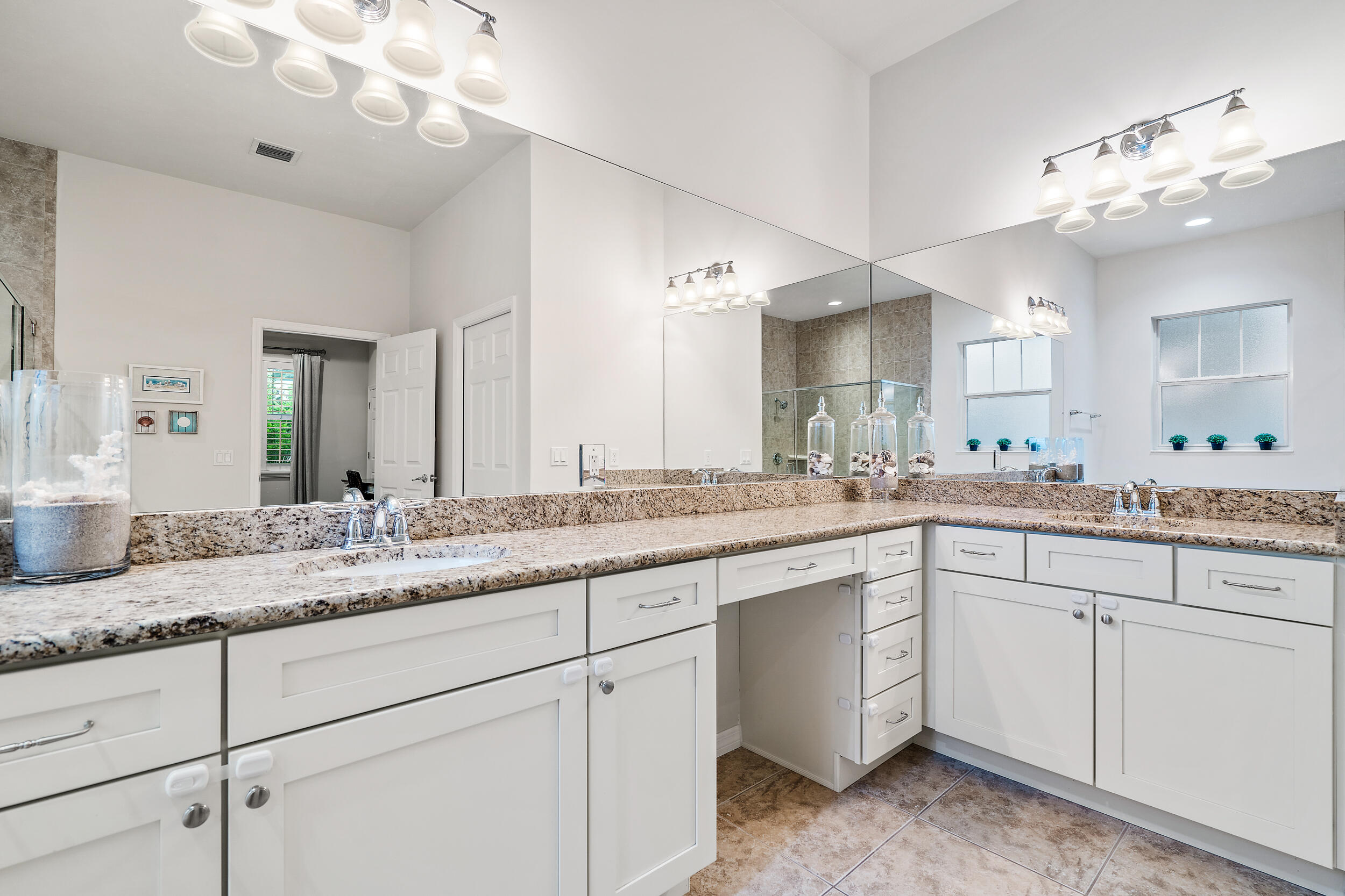 2704 Sunbury Drive Jupiter, FL 33458 - Photo 25 of 50 a bathroom with a sink vanity and mirror
