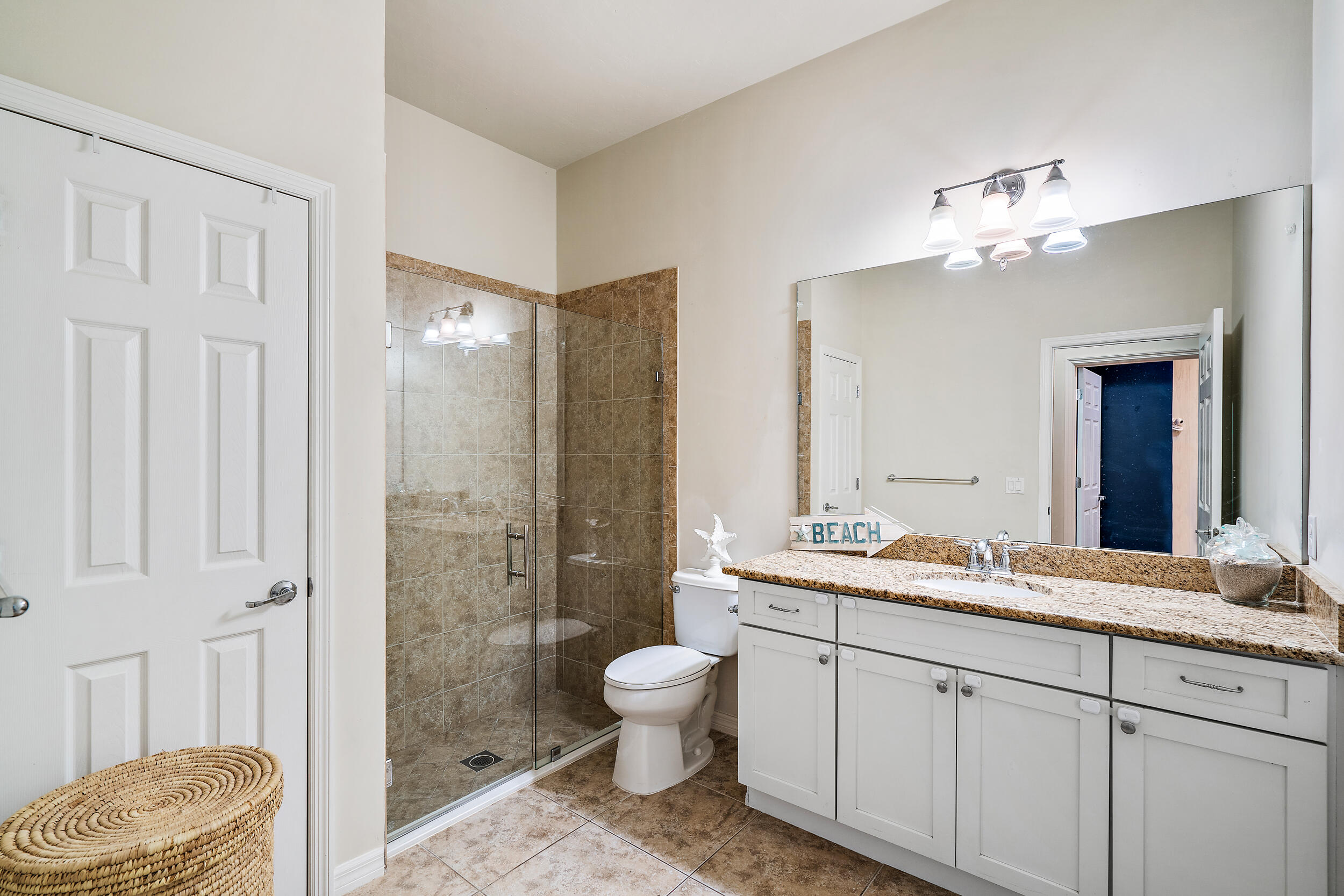 2704 Sunbury Drive Jupiter, FL 33458 - Photo 28 of 50 a bathroom with a granite countertop sink mirror toilet and shower