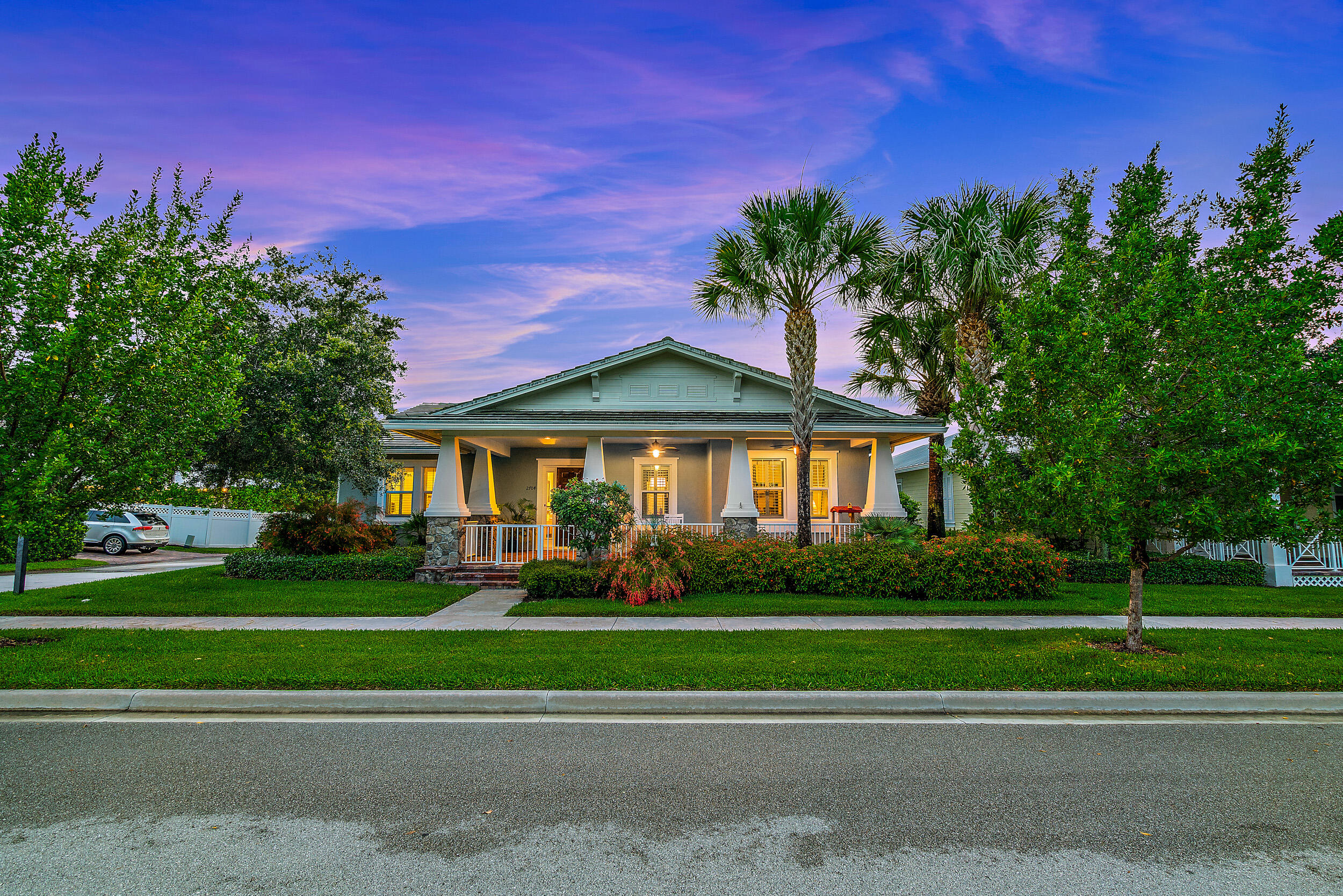 2704 Sunbury Drive Jupiter, FL 33458 - Photo 3 of 50 a front view of a house with a yard