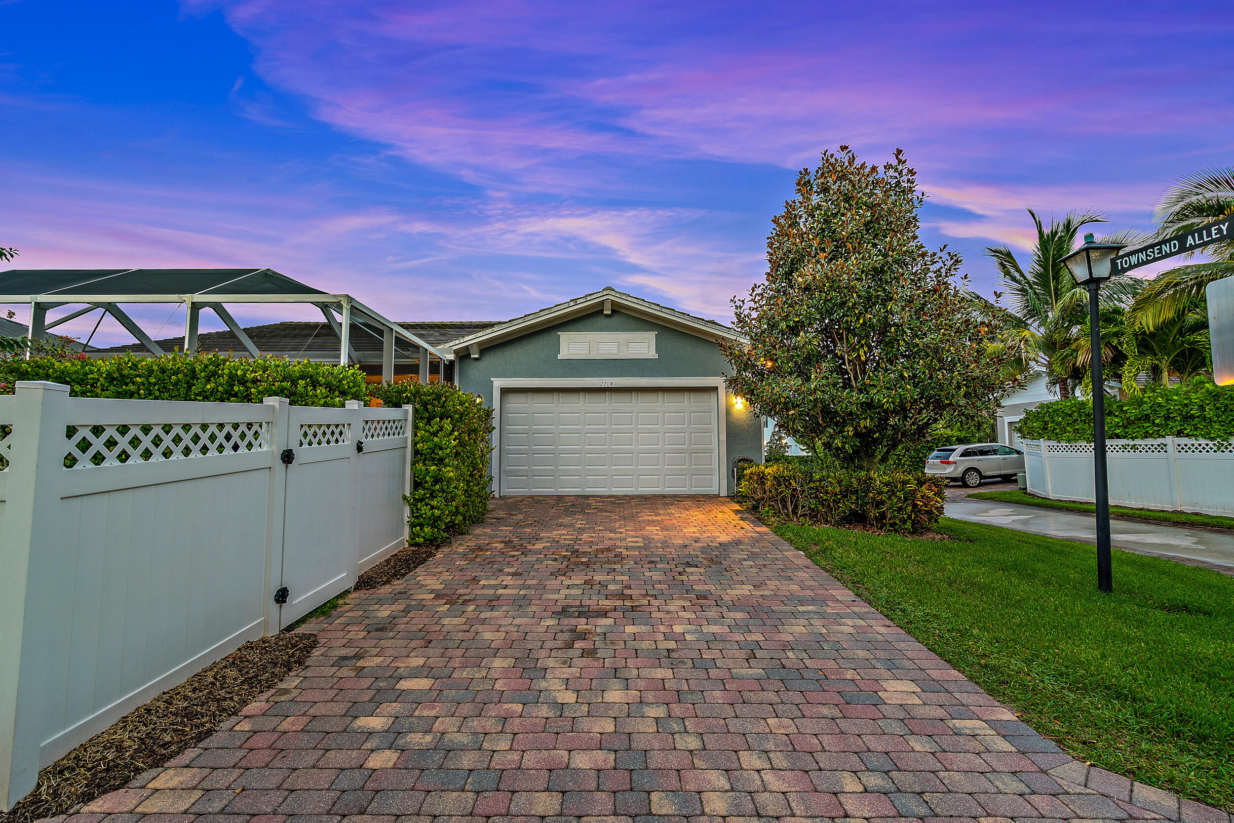 2704 Sunbury Drive Jupiter, FL 33458 - Photo 31 of 50 a front view of a house with a yard and garage