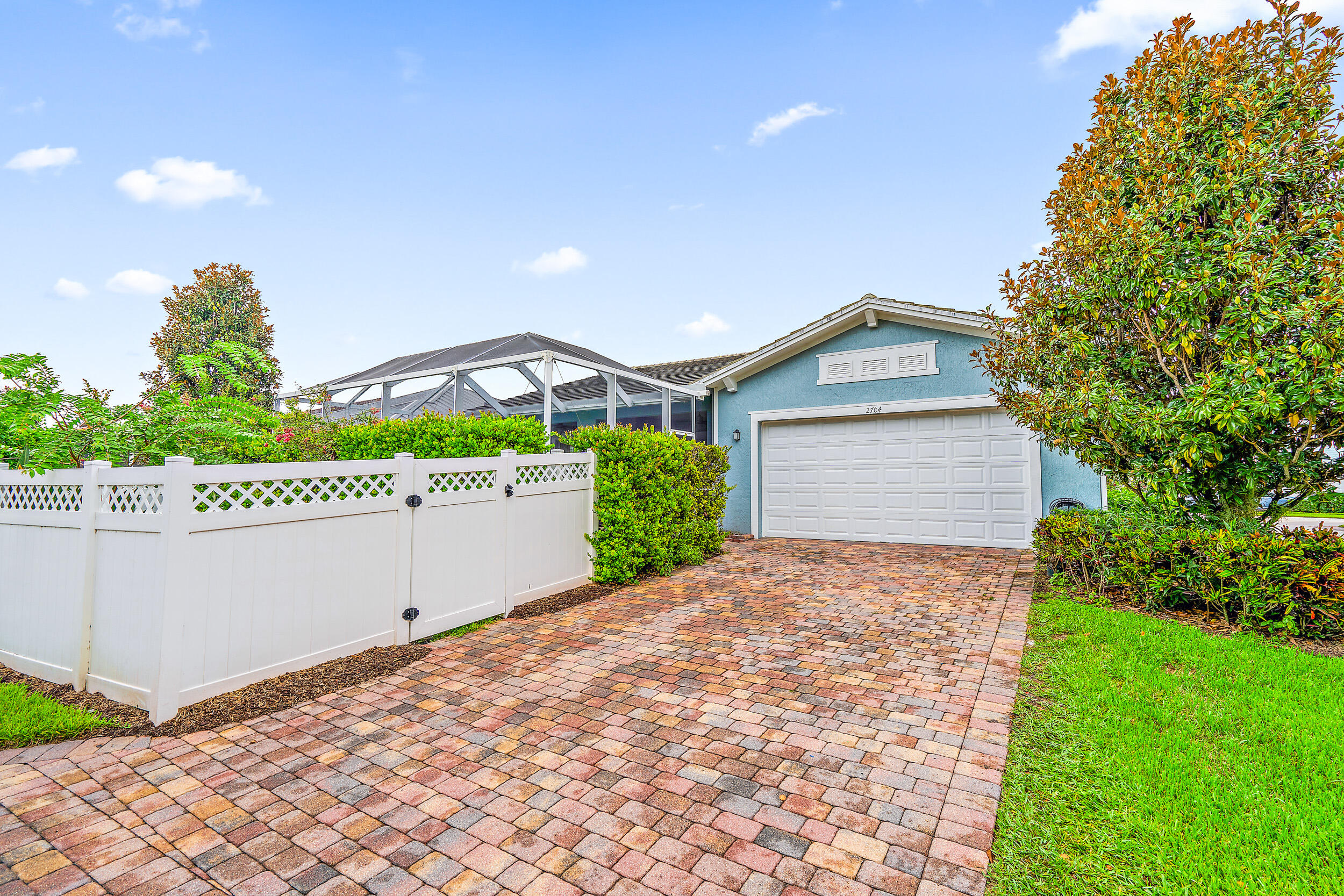 2704 Sunbury Drive Jupiter, FL 33458 - Photo 33 of 50 a front view of a house with a yard and garage