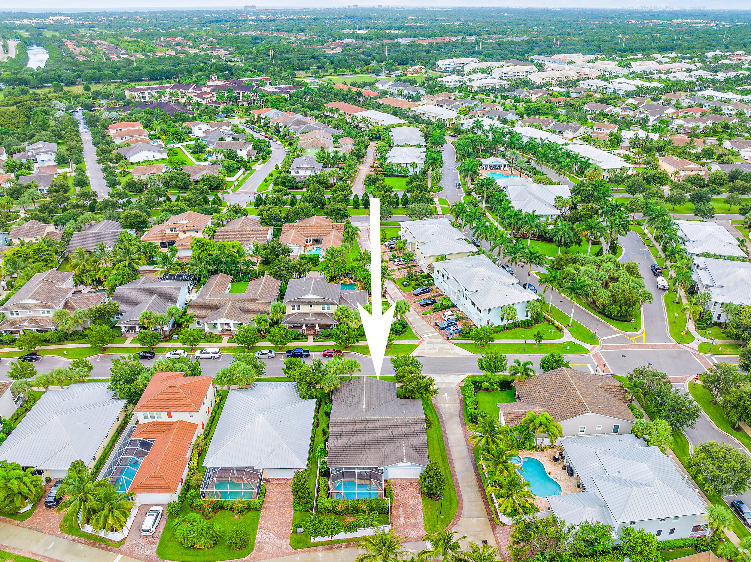 2704 Sunbury Drive Jupiter, FL 33458 - Photo 42 of 50 an aerial view of residential houses with outdoor space and trees