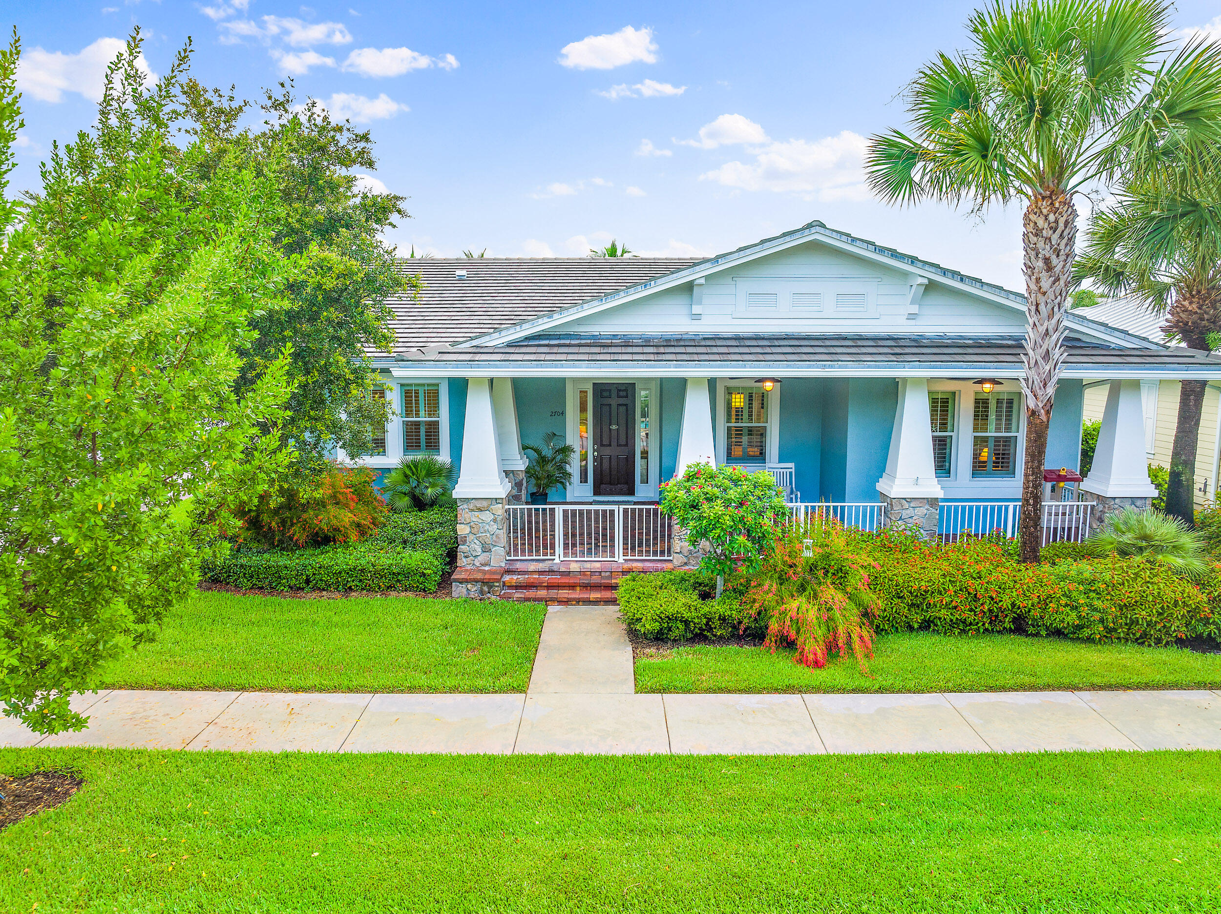 2704 Sunbury Drive Jupiter, FL 33458 - Photo 46 of 50 a front view of a house with a yard