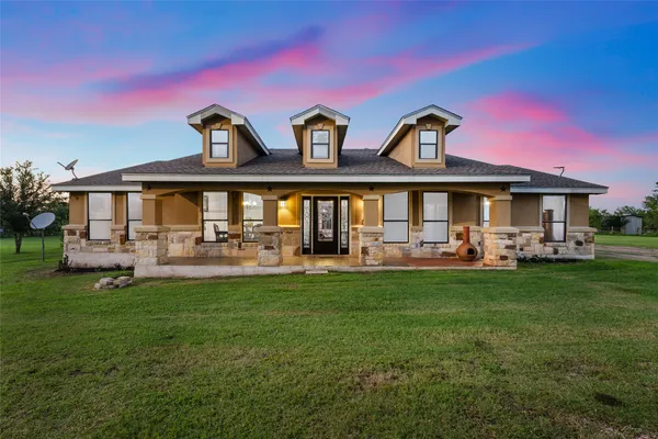 a front view of house with yard barbeque and outdoor seating