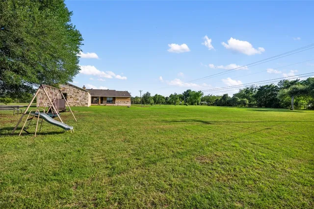 a view of a garden with a house