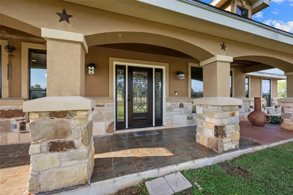 a front view of a house with outdoor seating