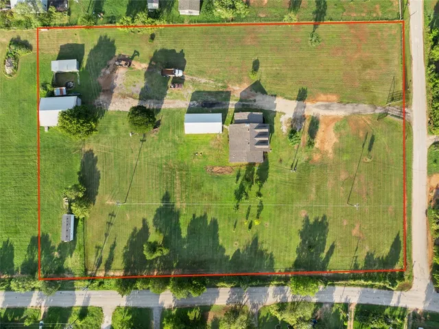 an aerial view of residential houses with outdoor space