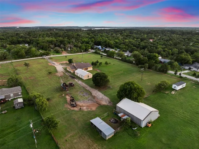 an aerial view of a house with a yard