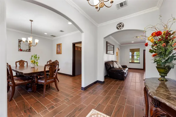 a view of a dining room with furniture and a potted plant