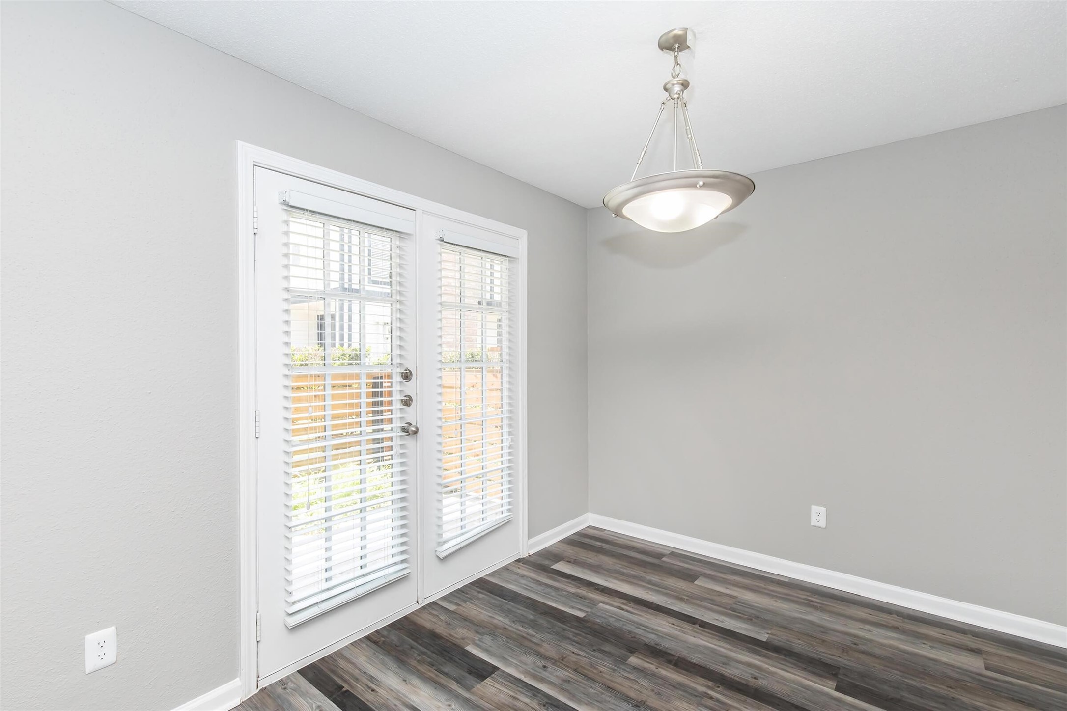 18001 Cypress Trace Road, Unit 503 Houston, TX 77090 - Photo 8 of 32 a view of an empty room with wooden floor and a window