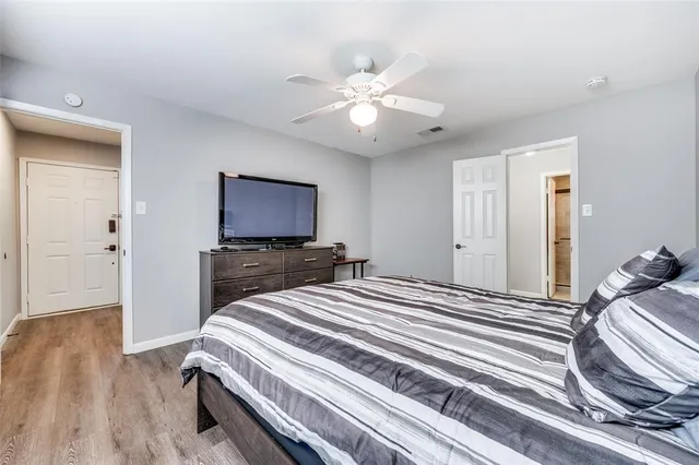 a spacious bathroom with a double vanity sink a large mirror and a shower
