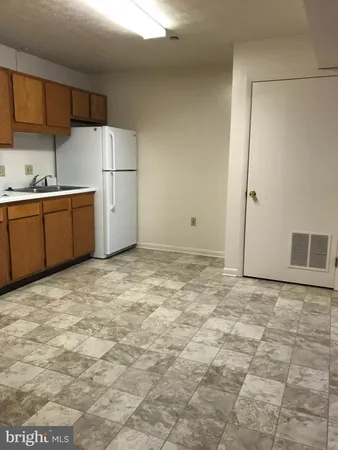 a view of a kitchen with a sink and cabinets