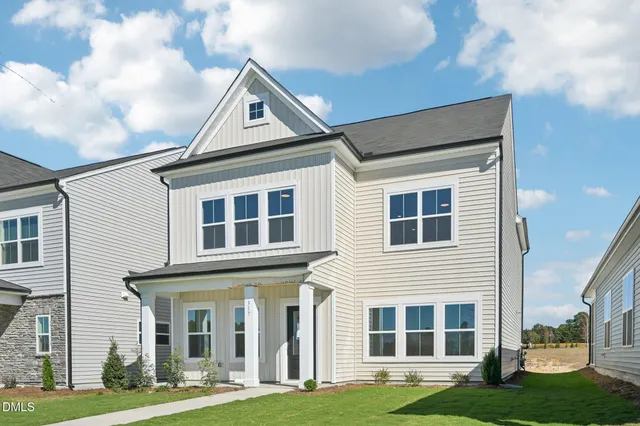 a front view of a building with a yard