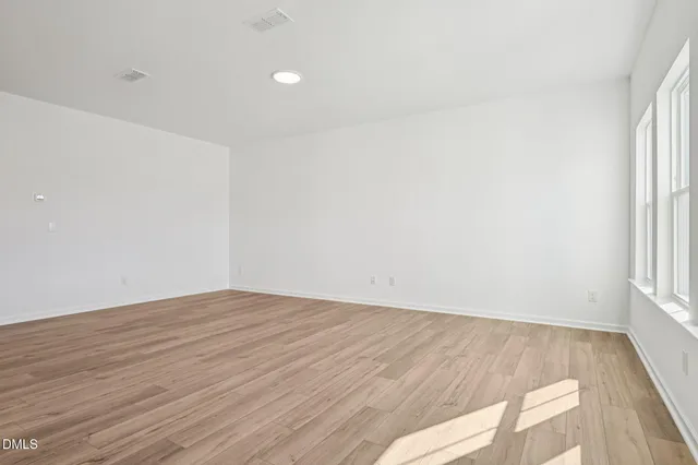 a kitchen with stainless steel appliances granite countertop a sink a stove and a wooden floors