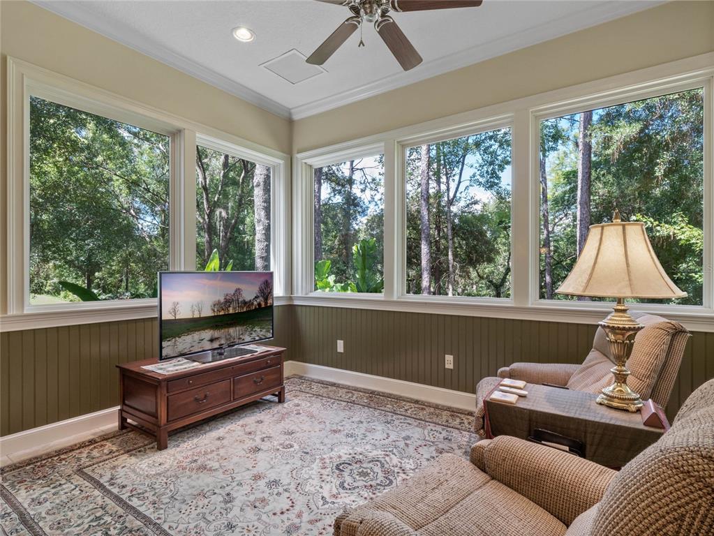 4000 Rouse Road Orlando, FL 32817 - Photo 20 of 53 a living room with furniture and a flat screen tv