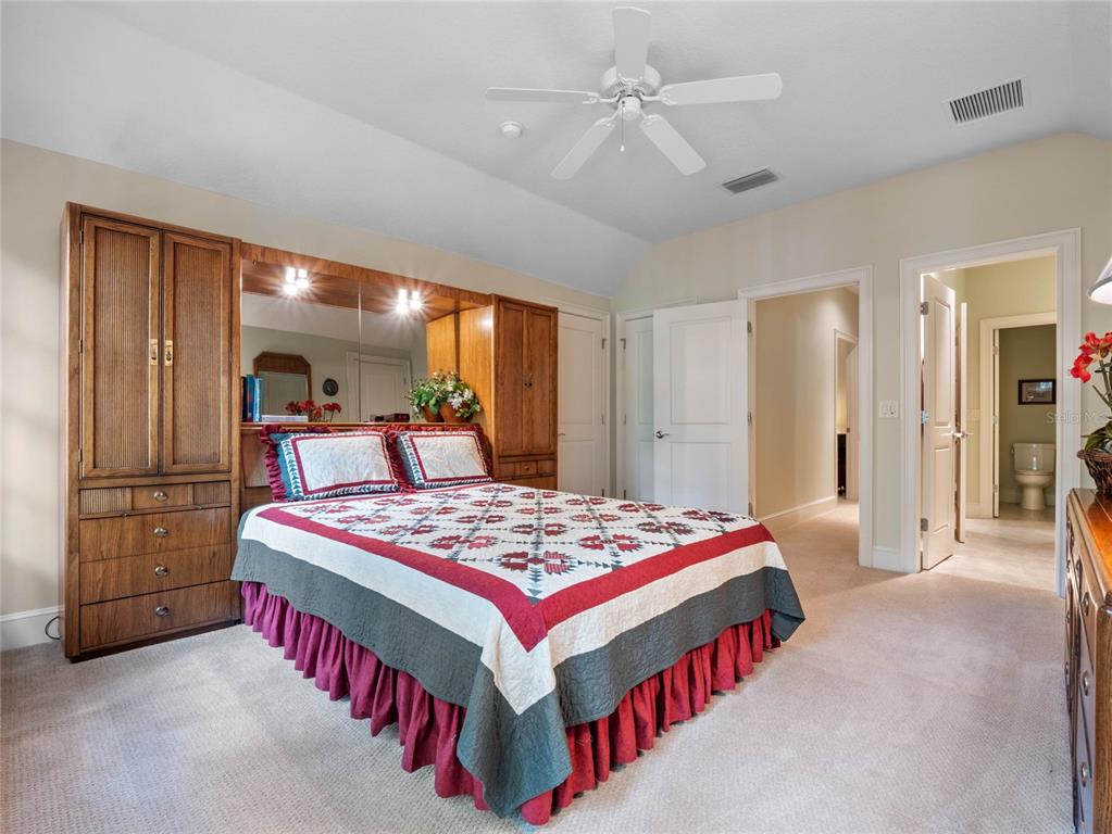 4000 Rouse Road Orlando, FL 32817 - Photo 28 of 53 a bedroom with a bed and dresser with mirror