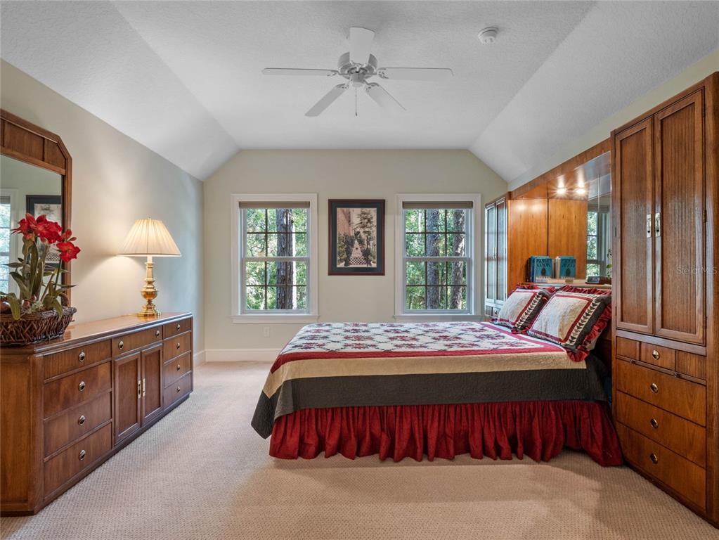 4000 Rouse Road Orlando, FL 32817 - Photo 29 of 53 a bedroom with a large bed and a chandelier