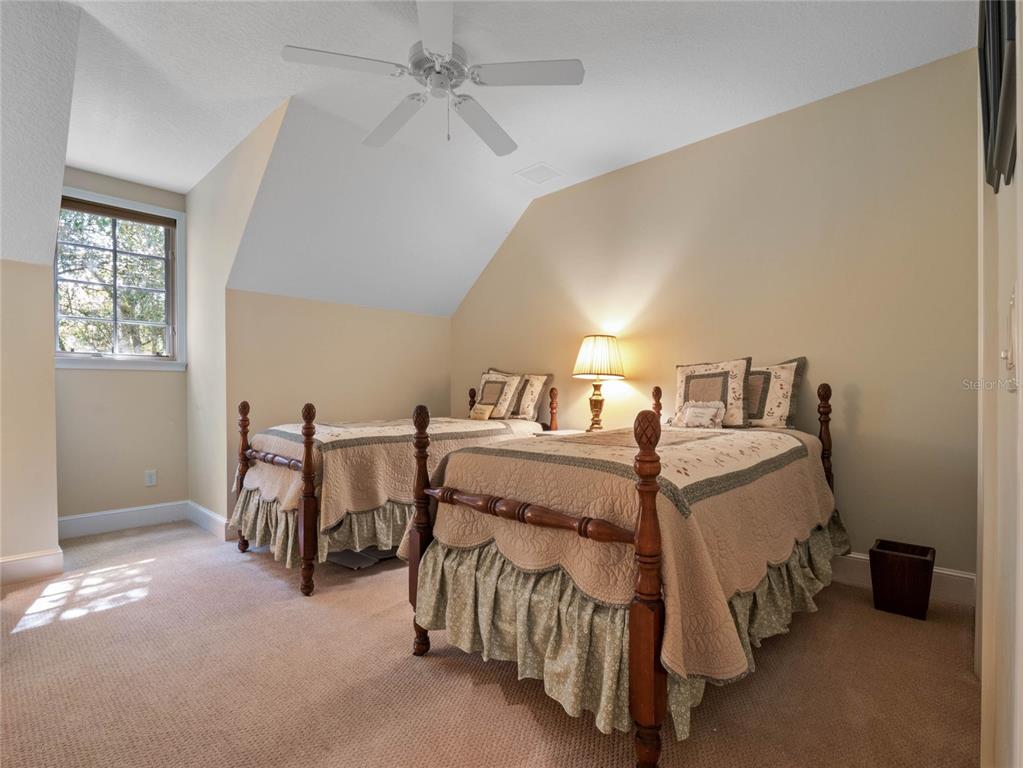 4000 Rouse Road Orlando, FL 32817 - Photo 30 of 53 a bedroom with a bed and a chandelier